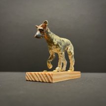 Jeff-Geib-Dog-on-Stand-with-Right-Paw-Up-clay-sculpture-wood-3-x-3.75-x-1.5-inches