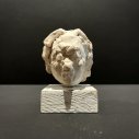 Jeff-Geib-Large-White-Head-on-White-Wood-Stand-clay-sculpture-and-wood-4-x-2.5-inches